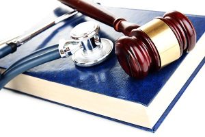 Gavel and stethoscope on book
