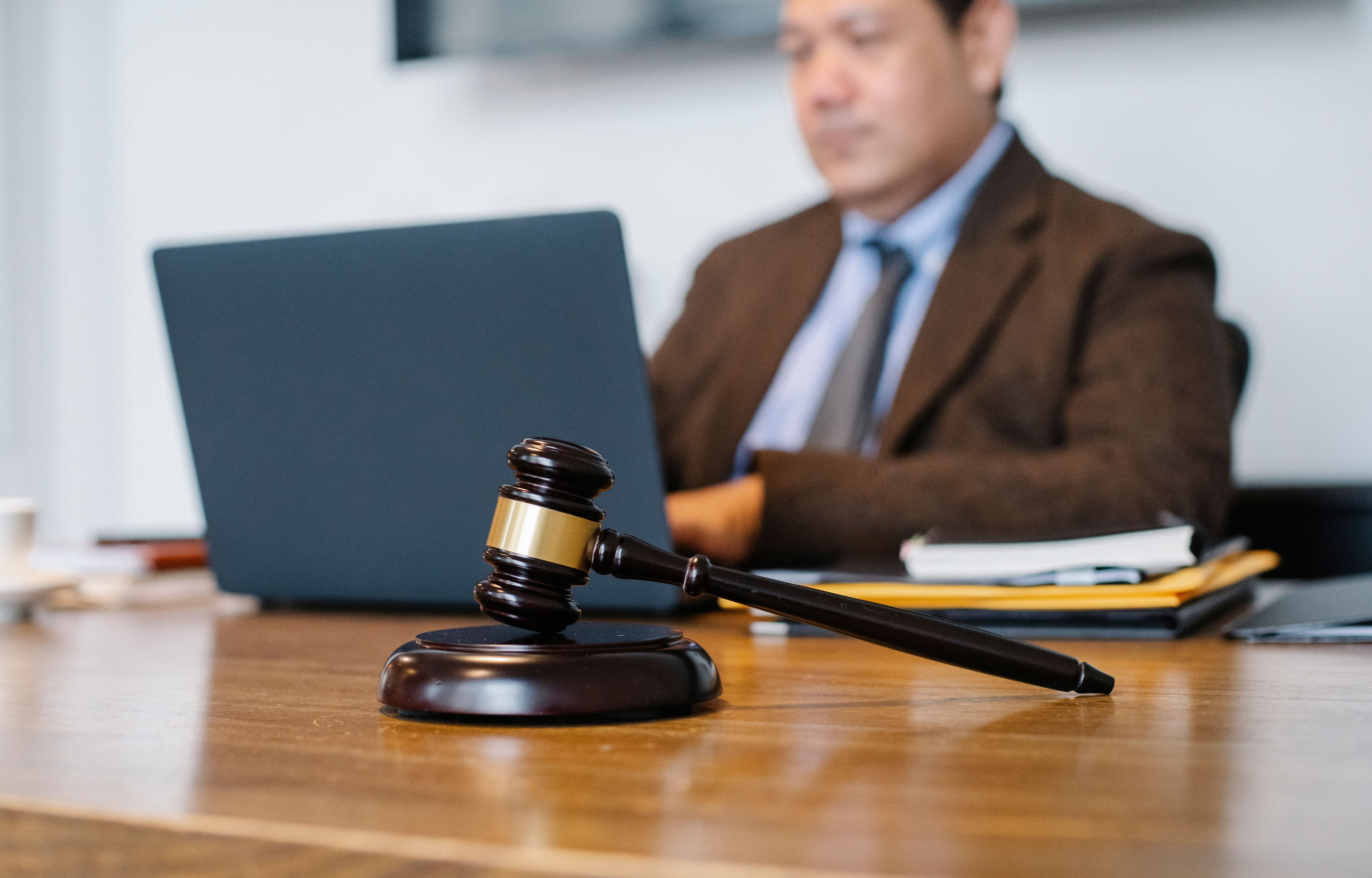 New Jersey personal injury lawyer working on a client's accident claim at a desk with a gavel in the foreground
