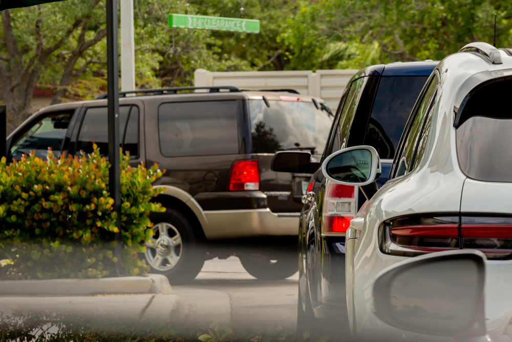 Cars lined up in a drive-thru lane, illustrating the risk of drive-thru accidents.