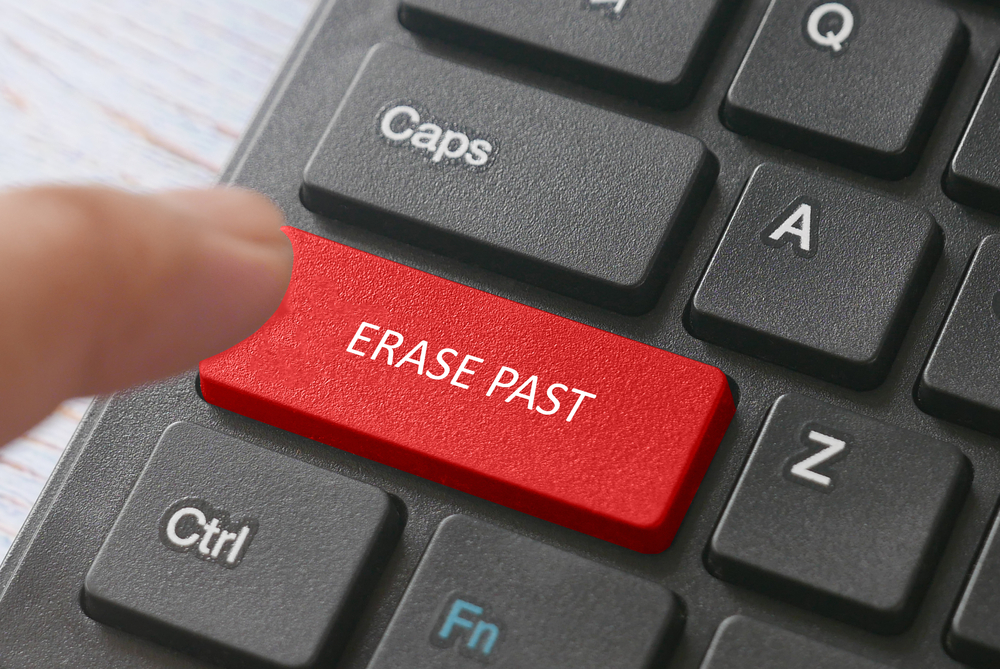 Finger pressing erase past key on keyboard symbolizing criminal record expungement and clearing a past record in New Jersey.