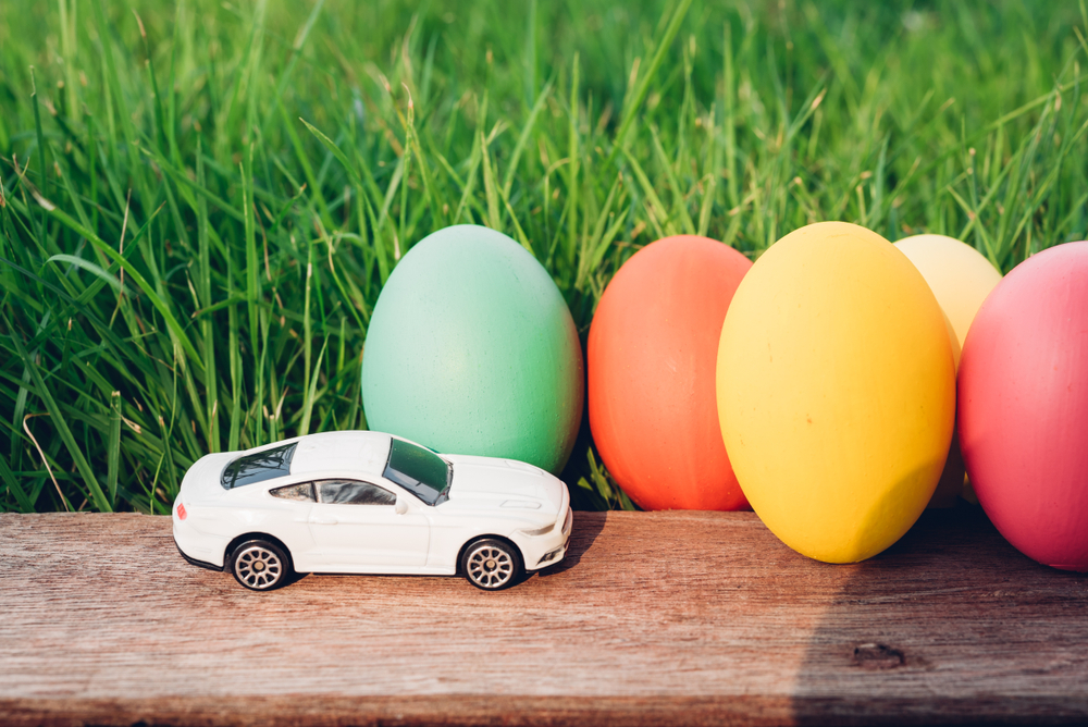 Toy car next to colorful Easter eggs representing Easter driving safety and holiday car accident risks