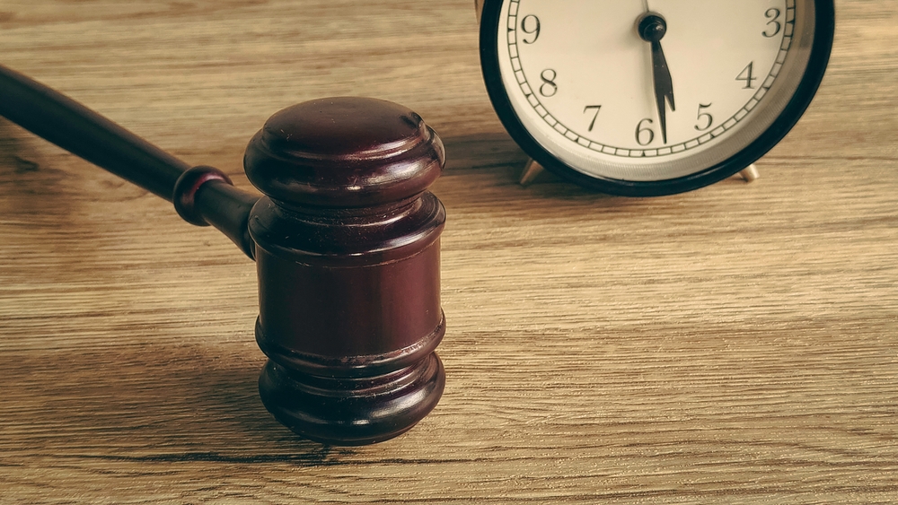 Wooden judge gavel and clock symbolizing court deadlines and legal time limits in New Jersey cases