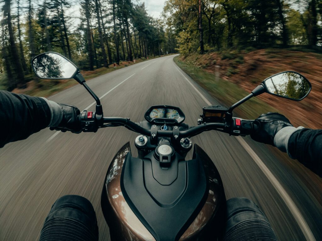 Motorcyclist riding on a winding road, highlighting the risks and common causes of motorcycle accidents in New Jersey.
