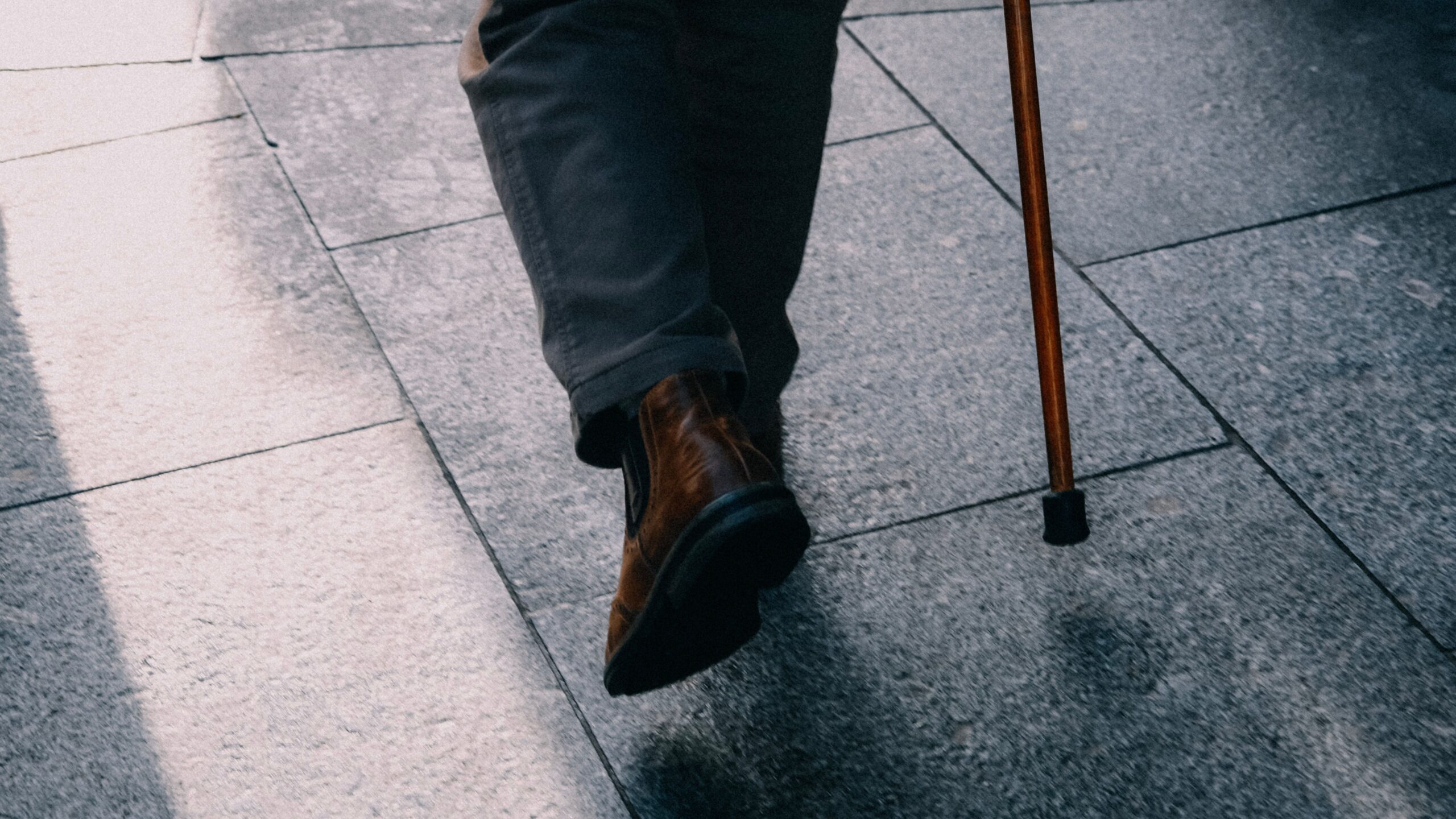 Senior walking with a cane after a slip and fall accident, highlighting injury risks for older adults in New Jersey.