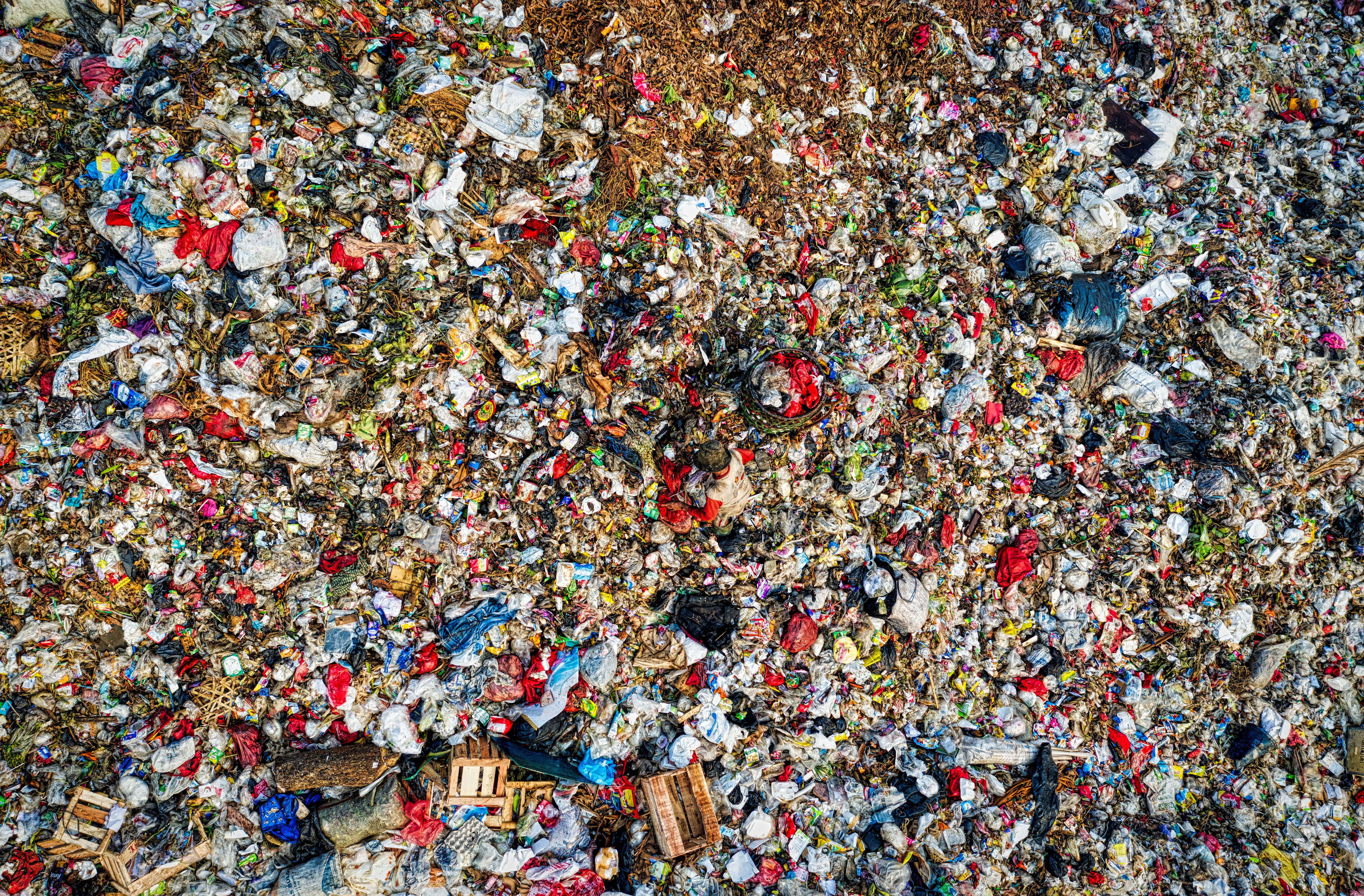 Aerial view of landfill waste pile, representing contamination concerns near Aeromarine. Learn who's liable and how to protect your claim. 