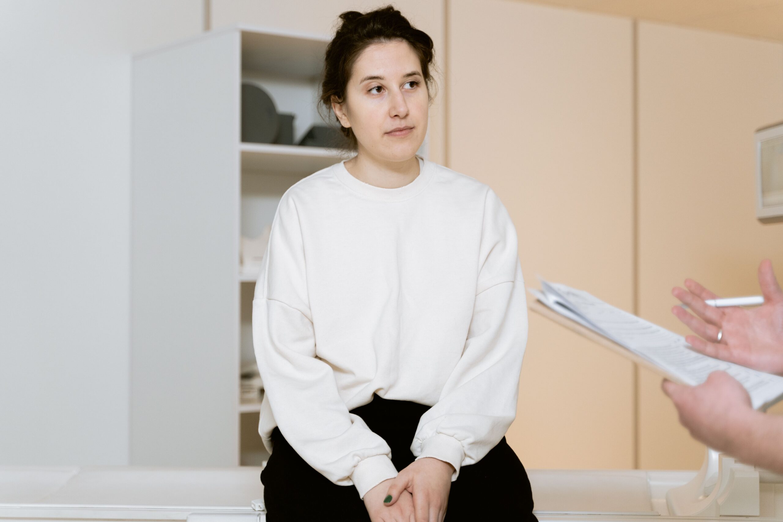 Patient listening to her doctor during an appointment and asking questions to help prevent a medical error.
